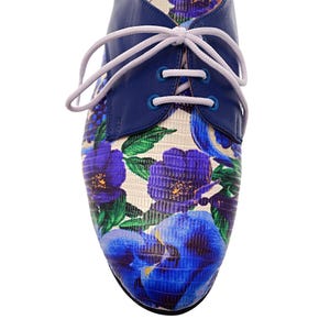 Fashionable handmade oxford shoes for women with bold blue flower pattern.