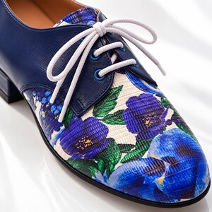 Close-up detail of blue floral Oxford shoe showing leather, laces and craftsmanship.