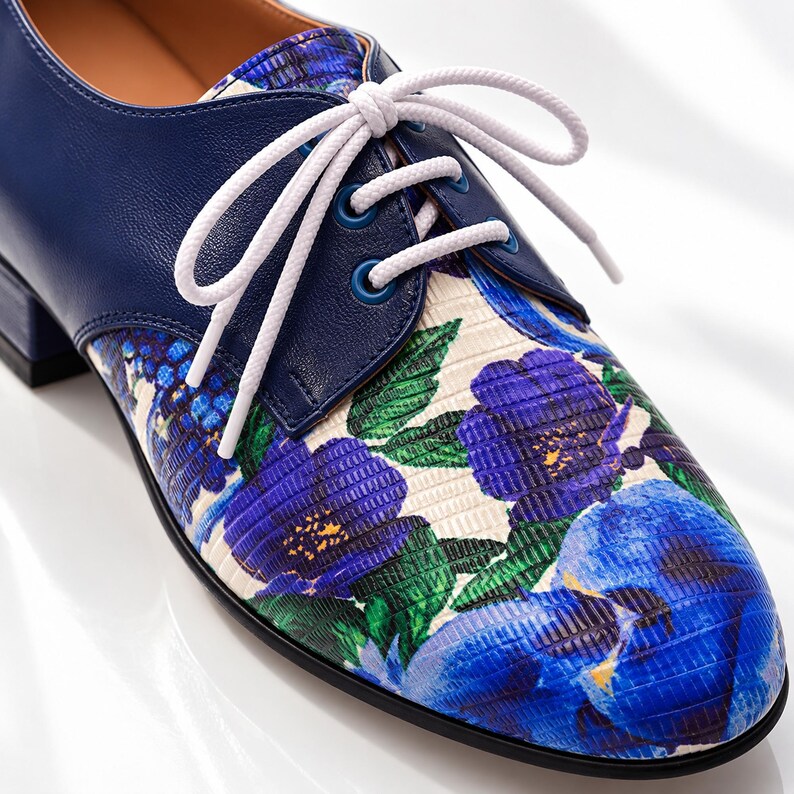 Close-up detail of blue floral Oxford shoe showing leather, laces and craftsmanship.