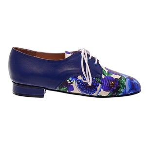 Blue floral print leather lace-up shoes photographed on white background.