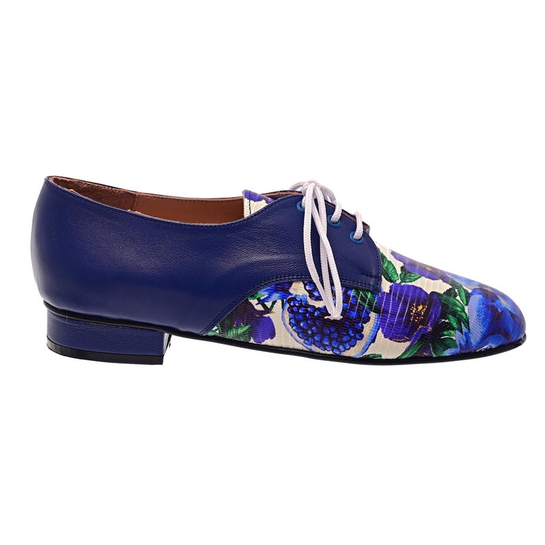 Blue floral print leather lace-up shoes photographed on white background.