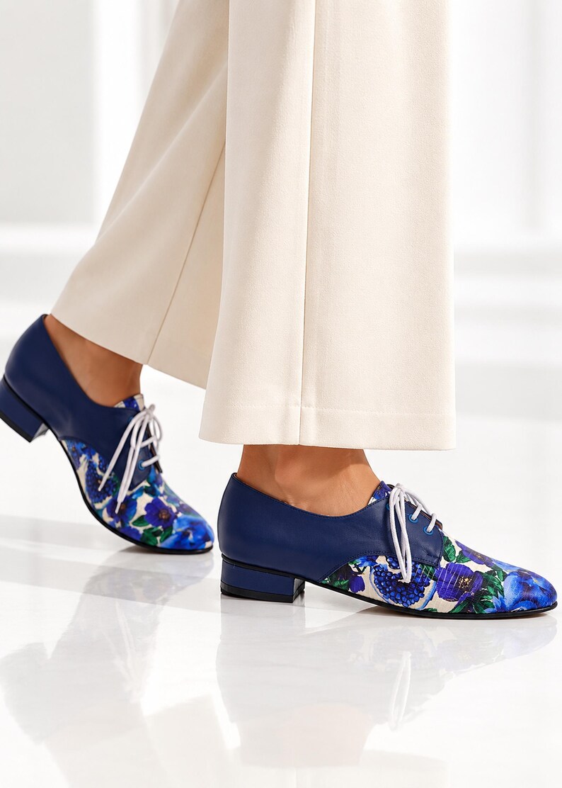 Side view of women’s blue floral Oxford shoes with low block heel.