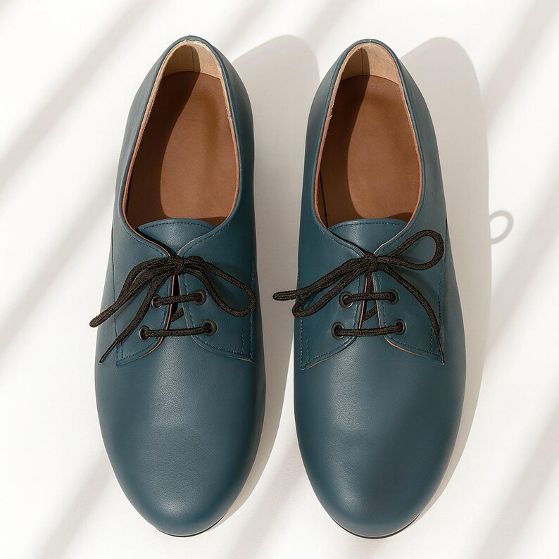 Women’s teal leather Oxford shoes with 3cm block heel and non-slip sole, displayed in natural light.