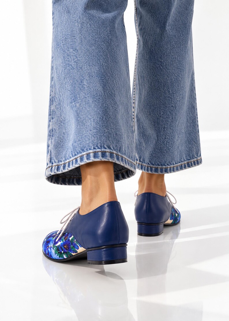 Back view of blue floral Oxford shoes showing the navy leather heel.