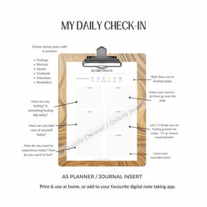 May include: A5 planner insert with the text "My Daily Check-In" on a wooden clipboard. The planner includes sections for feelings, worries, needs, gratitude, intentions, and reminders. It also has prompts for self-reflection.