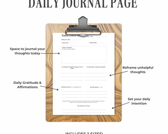 May include: A wooden clipboard holds a daily journal page with prompts for self-reflection. The page includes sections for daily check-in, gratitude, affirmations, and setting intentions. Text on the page encourages journaling thoughts, reframing thoughts, and includes 3 sizes.