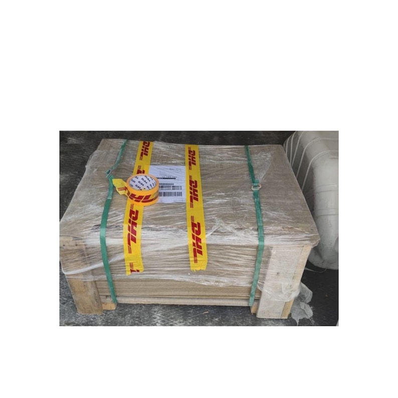 May include: A large cardboard box wrapped in clear plastic and secured with yellow tape. The box is labeled with the DHL logo and has a green strap around it.