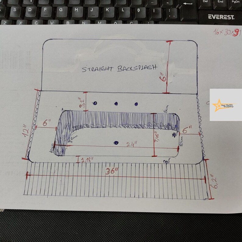 May include: A technical drawing on white paper showing a vanity countertop design with a straight backsplash. The sketch includes various measurements in inches, such as a 36-inch total width, a 6-inch backsplash height, and a 24-inch central cutout.