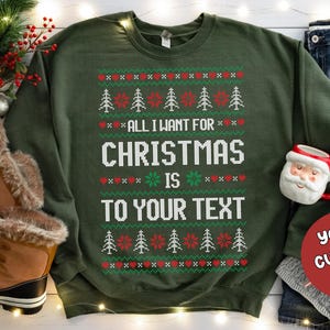 May include: Green Christmas sweater with a white knit pattern and the text "All I want for Christmas is to your text". A red circle with the text "Your Custom Text" is in the lower right corner.