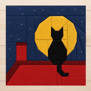 May include: A fabric quilt block featuring a black cat silhouette sitting on a red roof against a large yellow moon. The background is a dark blue night sky with small white star accents. The design is constructed from geometric fabric pieces.