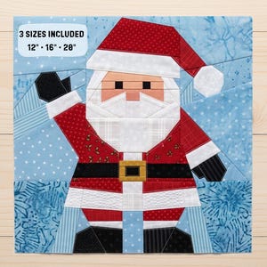 May include: A fabric quilt block pattern featuring a stylized Santa Claus in red, white, and black against a light blue background with white snowflakes. The text 3 SIZES INCLUDED 12" - 16" - 20" is printed in the upper left corner of the design.