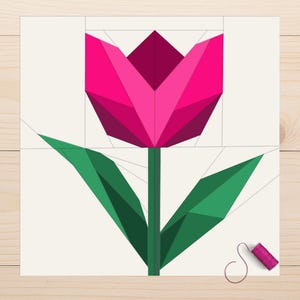 May include: A geometric illustration of a tulip in shades of pink and green. The flower has a dark pink center and lighter pink petals. Green leaves and stem complete the design. A spool of pink thread sits nearby.