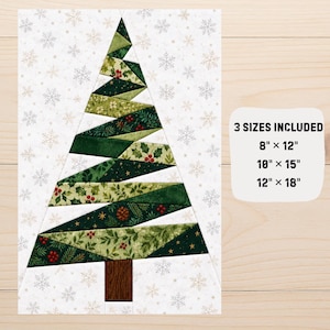 Könnte beinhalten: Ein gestepptes Weihnachtsbaummuster auf weißem Hintergrund mit Schneeflockenmotiven. Der Baum besteht aus grünen Stoffstreifen mit Stechpalmen-, Kiefern- und Beerenmustern. Text: 3 SIZES INCLUDED 8" x 12" 10" x 15" 12" x 18".