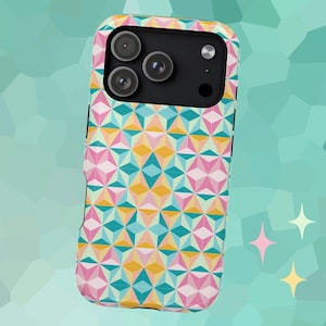 May include: A colorful phone case with a geometric pattern in pink, yellow, teal, and white. The case has a black camera module with three lenses and a flash. The design is a repeating pattern of three-dimensional shapes.