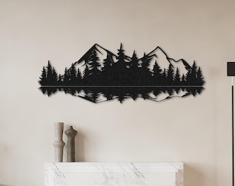 May include: Black metal wall art depicting a mountain range reflected in a lake. The art piece is mounted on a white wall above a fireplace.
