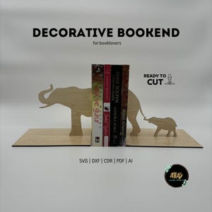 May include: Decorative wooden bookend featuring an elephant design. The bookend is made of light-colored wood and includes the text "DECORATIVE BOOKEND" and "for booklovers". The bookend is designed to hold books.