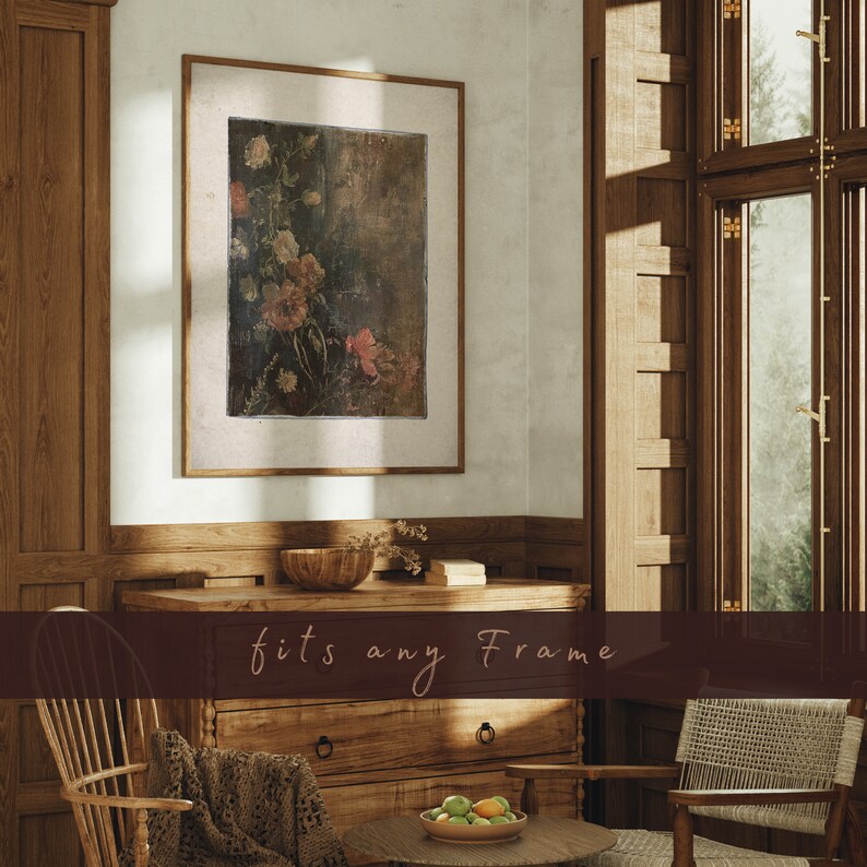 May include: A framed floral print with a vintage aesthetic, featuring pink and white flowers on a dark background. The print is displayed in a living room setting with wooden furniture and natural light.