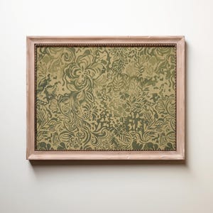 May include: A rectangular wall art piece featuring a light wooden frame with a distressed finish. The artwork displays a dense, repeating pattern of stylized floral and leafy motifs in varying shades of olive green and muted tan colors.