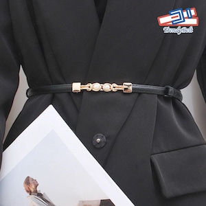 May include: A black blazer with a black belt featuring a gold chain with pearl accents. The belt has the text "TrendyBelt" on it.