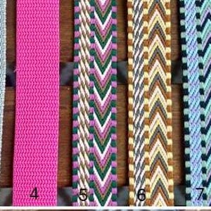 May include: Nine colorful woven straps are displayed vertically. The straps vary in color, including navy blue, gray, pink, and patterned designs with green, white, and brown. Each strap is numbered from one to nine.