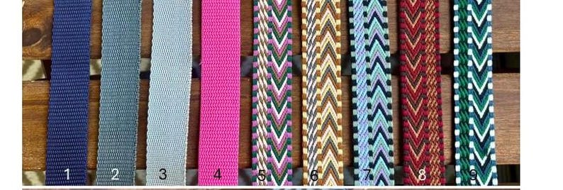 May include: Nine colorful woven straps are displayed vertically. The straps vary in color, including navy blue, gray, pink, and patterned designs with green, white, and brown. Each strap is numbered from one to nine.