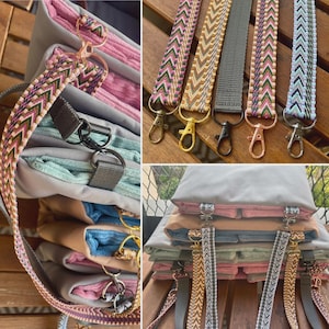 May include: A collection of colorful purse straps with various patterns and metal clasps. The straps are in shades of pink, green, gray, and gold. The image also shows a stack of folded fabric items.