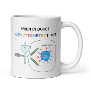 May include: White ceramic mug featuring a colourful illustration of a flow cytometry experiment. The text on the mug reads "When in doubt, flow cytometry it out." and "I go with the flow."