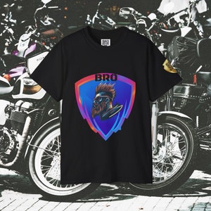 May include: Black t-shirt with a graphic of a bearded man wearing sunglasses in a colorful shield with the word "BRO" above him.