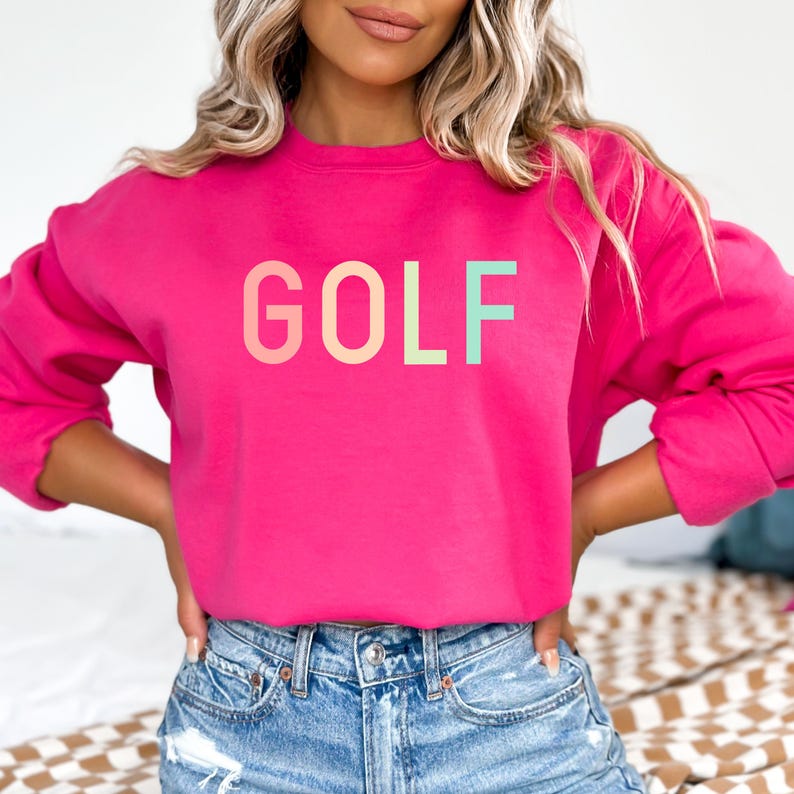 Women's crewneck sweatshirt that says Golf in it in pastel letters. This is a trendy sweatshirt that makes a great gift for women golfers, or golf lovers!