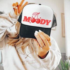 Trendy trucker hat for women that says Moody with Cherries on it. This coquette snapback hat is modern and perfect for bachelorette parties, girls trips, pool parties, and for beach days. Grab this mesh hat with cherries on it today!