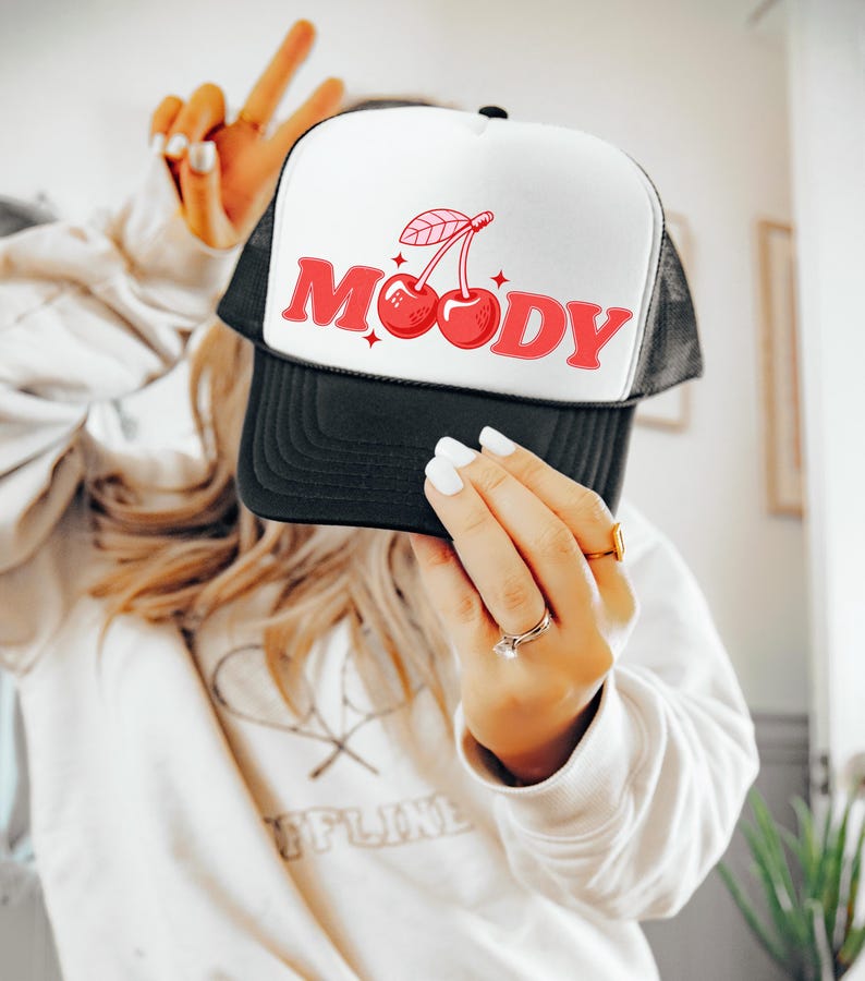 Trendy trucker hat for women that says Moody with Cherries on it. This coquette snapback hat is modern and perfect for bachelorette parties, girls trips, pool parties, and for beach days. Grab this mesh hat with cherries on it today!