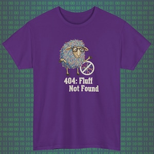 May include: A purple t-shirt featuring a cartoon sheep wearing glasses and holding a broken wheel. The text "404: Fluff Not Found" is below the sheep. The background has a green binary code pattern.