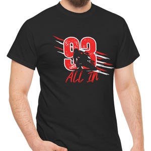 May include: Black t-shirt with a red and white graphic of a person riding a motorcycle with the number 93 and the text "All In".