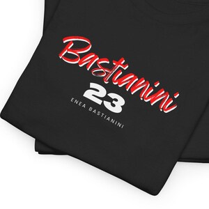 Könnte beinhalten: Schwarzes T-Shirt mit rotem und weißem Text, der "Bastianini 23" und "Enea Bastianini" in weißer Schrift lautet.