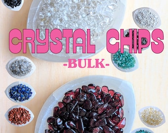 May include: A selection of crystal chips in bulk, including clear quartz, garnet, and other colours. The chips are displayed in small white bowls on a wooden surface. The text "CRYSTAL CHIPS -BULK- " is displayed in pink letters.