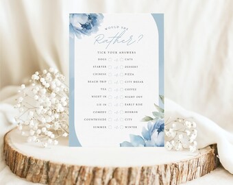 May include: A blue and white printable game card with the text "Would She Rather?" and a list of questions with two choices each. The card has a watercolor floral design.