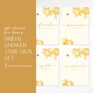 May include: Set of five printable bridal shower table signs with a honeybee theme. The signs feature a watercolor illustration of a honeycomb with dripping honey and the text "food", "favors", "gifts", "guest book", and "She found her honey".