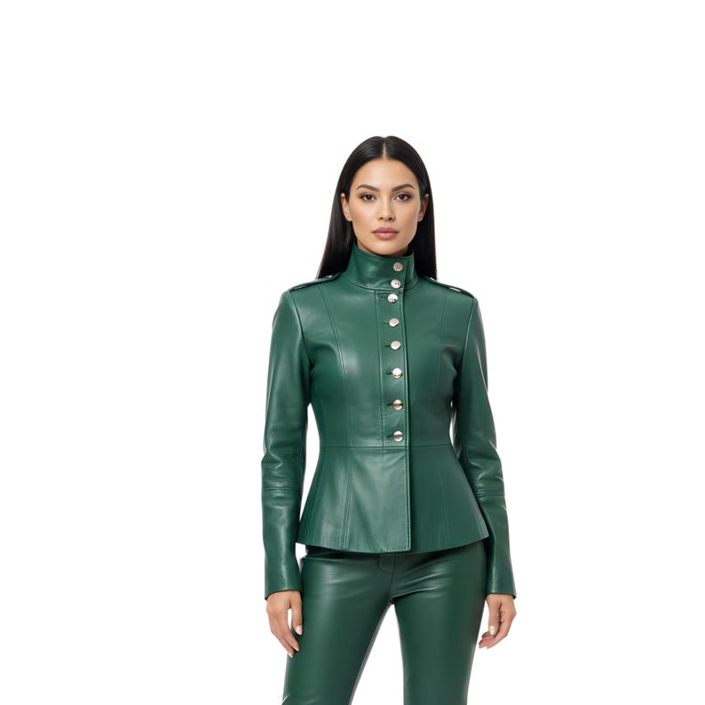 May include: A green leather jacket with a high collar and silver buttons. The jacket has a fitted silhouette and long sleeves. The model is also wearing matching green leather pants.
