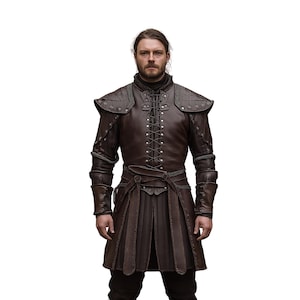 May include: A man wearing a brown leather jacket with a lace-up front and a matching skirt. The jacket has decorative stitching and a belt.