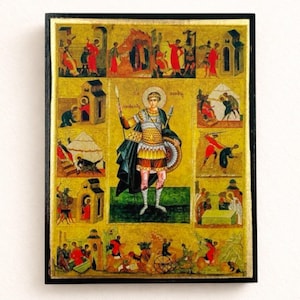 Puede incluir: Icono religioso enmarcado que presenta una figura central con armadura sosteniendo una lanza y un escudo, rodeada de escenas más pequeñas. La obra de arte tiene un fondo dorado con detalles en rojo, amarillo y azul, y está encerrada en un marco negro.