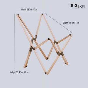 May include: A wooden folding chair with metal hinges. The chair is 26 inches wide, 32 inches deep, and 35.4 inches high. The chair is made of natural wood and has a light brown color.