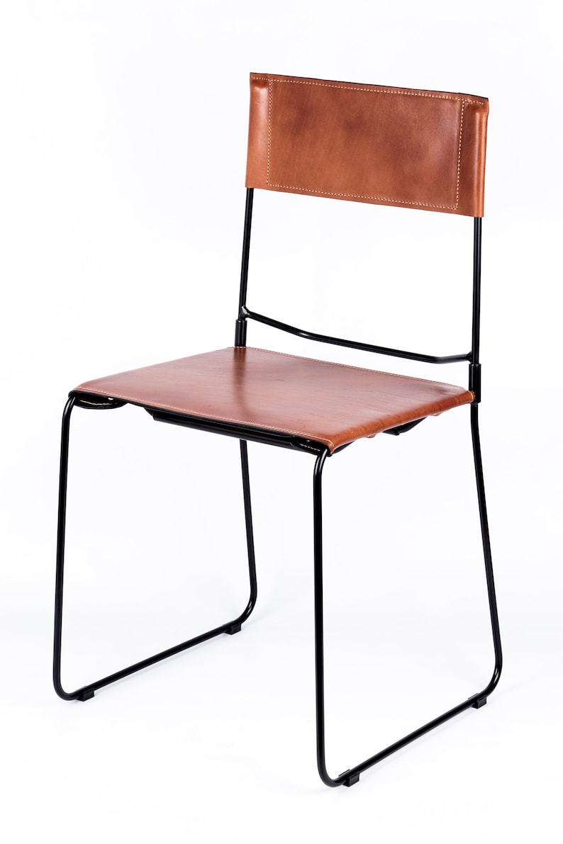 May include: A black metal chair with a brown leather seat and back.