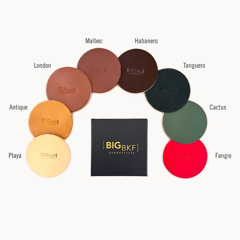 May include: Ten leather coasters in various colors, each with the text "BIGBKF" embossed in gold. The coasters are arranged in a circle around a black box with the text "BIGBKF BUENOS AIRES" printed in gold.