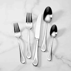 May include: A set of five silver-toned flatware pieces with a Christmas tree design. The set includes a knife, a fork, and three spoons.