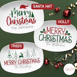 May include: Three white oval serving platters with red and green Christmas designs. The platters feature the text "Merry Christmas" with different holiday-themed illustrations and personalized names. The platters are on a green background with gold and red ribbon.