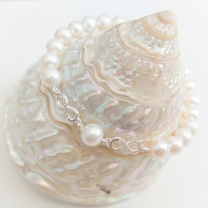 Eternity Pearl Bracelet:  round-shaped natural freshwater pearls, shimmering in their pristine white hue, with sterling silver accents
