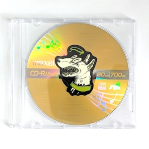 May include: A gold CD-R disc with a cartoon dog graphic in a clear plastic case. The disc has the text "maxell CD-R Music" and "80 min 700MB". Musical notes are also visible.