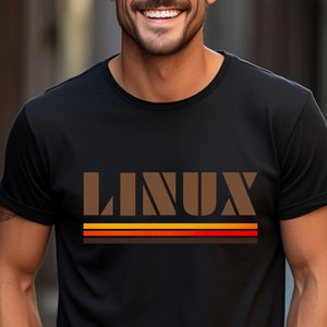 May include: A black t-shirt with a brown "LINUX" graphic and colourful stripes.