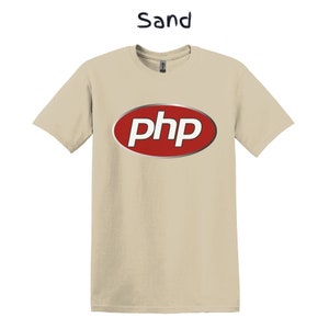 May include: A sand coloured t-shirt with a red oval logo that says "php" in white letters.