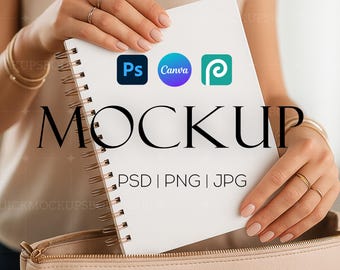 May include: A white notebook with a spiral binding, featuring the logos of Photoshop, Canva, and a design platform. The notebook is held by a hand and the text "MOCKUP PSD | PNG | JPG" is printed on the notebook.
